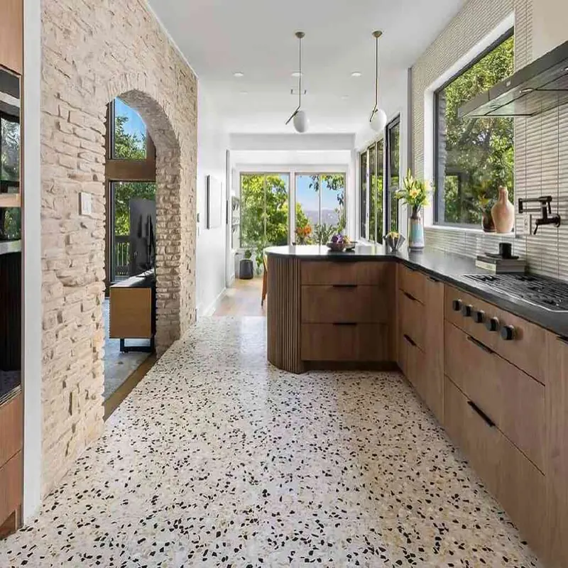 Kitchen with wood cabinets and speckled terrazzo floor