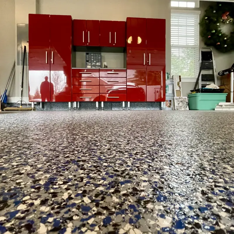 Red garage cabinets on blue flake epoxy flooring