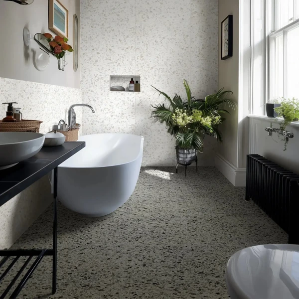 White bathroom on grey speckled terrazzo floor